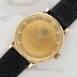 angled shot highlighting the 18k yellow gold case design and crosshair dial details of a Universal Genève Polerouter De Luxe