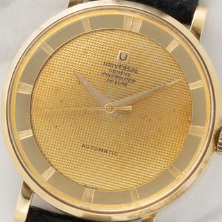 Macro close-up of the rare tapisserie textured gold dial and non-luminous hands on a Gérald Genta designed Universal Genève Polerouter