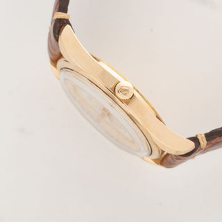 Side profile view showcasing the signed winding crown, acrylic crystal, and sharp twisted lug edges of an 18k pink gold UG Polerouter