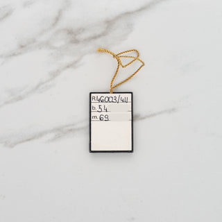 Back of the original serialized hang tag displaying reference number 46003/411