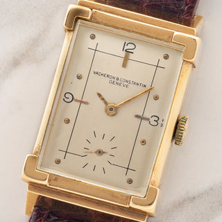 Macro close-up shot of the raised enamel sector dial, Arabic numerals at 12, 3, and 9, and small seconds register on a Vacheron Constantin Tank