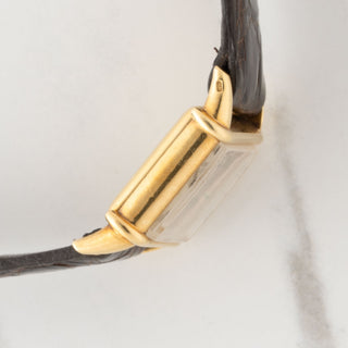 Side view displaying the architectural Tank Chinoise case lines and deep gold hallmarks on a vintage Vacheron