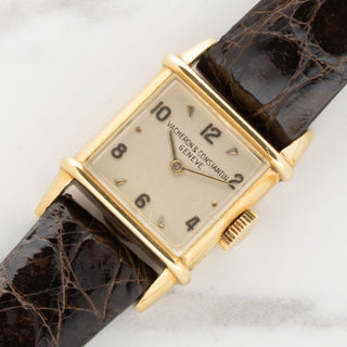 Angled shot highlighting the 18k gold Tank Chinoise case architecture and enamel signature on a ladies Vacheron Constantin