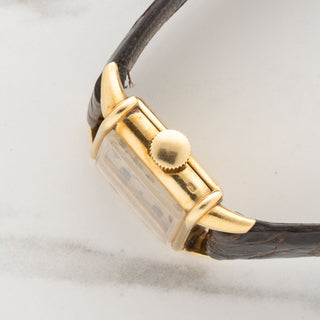 Side profile view showcasing the slim 18k gold case design and winding crown of a vintage Vacheron Constantin Tank Chinoise