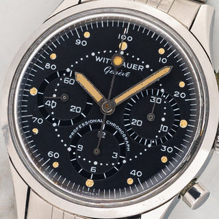 Macro close-up shot of the matte black dial, oversized luminous plots, decimal scale, and lollipop chronograph hand on a Wittnauer 242T