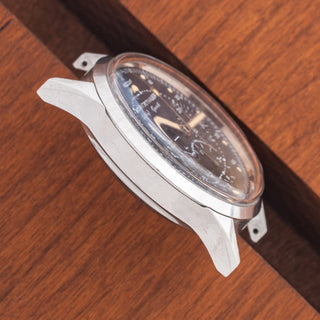 Angled top view highlighting the unpolished lug architecture and sharp factory proportions of a Wittnauer 242T